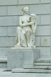 a statue of a woman holding a flower